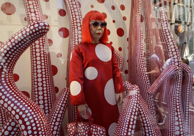 People pose with Yayoi Kusama's dotted pumpkins at Siam Paragon as part of  a launch event for the Louis Vuitton x Yayoi Kusama collection…